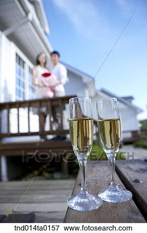couple in front of table with two glasses ofchampagne View Large Photo Image Stock Photo - couple in front of table with two glasses ofchampagne. Fotosearch