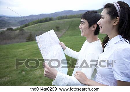 Stock Photo - couple looking at something with map. Fotosearch