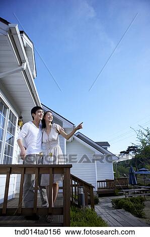 Stock Photograph - couple looking out in the balcony. Fotosearch
