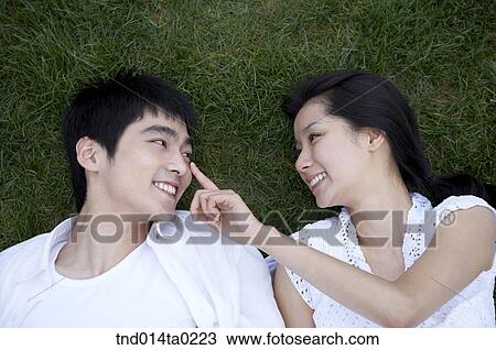 couple playing game on the grass field View Large Photo Image Stock Image - couple playing game on the grass field. Fotosearch