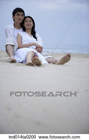 couple sitting on the sandy beach View Large Photo Image Stock Image - couple sitting on the sandy beach. Fotosearch