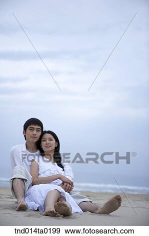 couple sitting on the sandy beach View Large Photo Image Stock Photo - couple sitting on the sandy beach. Fotosearch