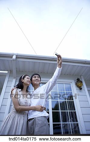 Stock Photography - couple taking pictures with camera. Fotosearch