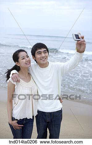couple taking picutre with thier digital camera View Large Photo Image Stock Photograph - couple taking picutre with thier digital camera. Fotosearch