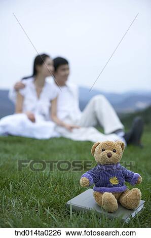 doll and couple on the grass field View Large Photo Image Stock Photograph - doll and couple on the grass field. Fotosearch