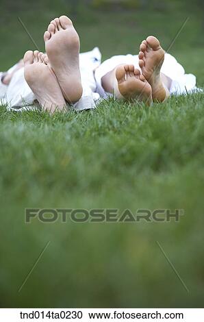 foot of the couple on the grass field View Large Photo Image Stock Image - foot of the couple on the grass field. Fotosearch