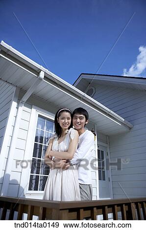Stock Photo - Newly married couple hug in the balcony. Fotosearch