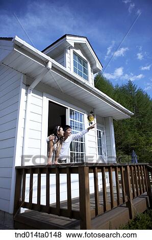 Stock Photo - Newly married couple looks out near the window. Fotosearch