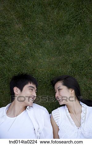 rest, grass field???? facing each other happy, merry couple View Large Photo Image Picture - rest, grass field???? facing each other happy, merry couple. Fotosearch