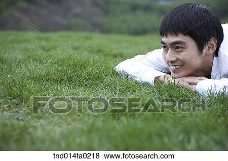 rest, grass field? lying prone man View Large Photo Image Stock Photo - rest, grass field? lying prone man. Fotosearch