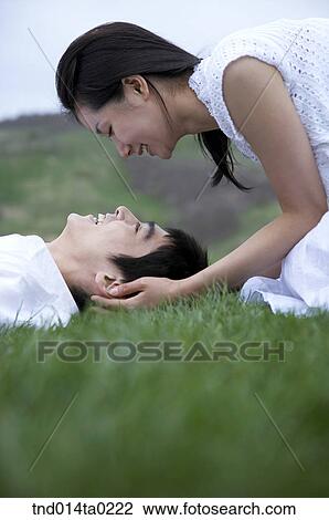 Stock Image - side of the couple facing each other . Fotosearch