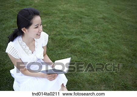 woman sitting and reading ont the grass View Large Photo Image Stock Image - woman sitting and reading ont the grass. Fotosearch
