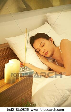 sleepign woman in the bed with candle and incense. View Large Photo Image Stock Photograph - sleepign woman in the bed with candle and incense.. Fotosearch