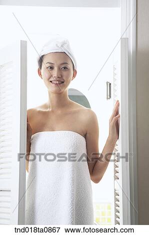 Stock Photo - woman coming inside the door. Fotosearch