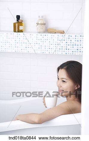 woman drinking tea while her bath View Large Photo Image Picture - woman drinking tea while her bath. Fotosearch