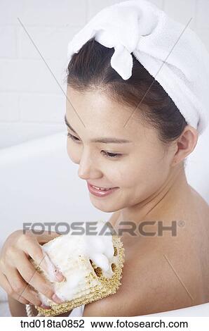 woman scrubbing her body with sponge View Large Photo Image Stock Image - woman scrubbing her body with sponge. Fotosearch