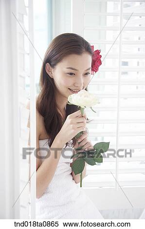 woman smell of flower near window View Large Photo Image Stock Photography - woman smell of flower near window. Fotosearch