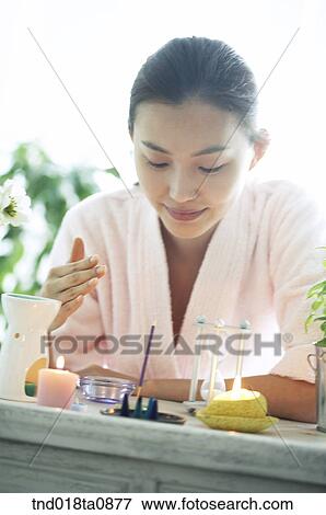 woman smelling the incense candle View Large Photo Image Stock Photo - woman smelling the incense candle . Fotosearch