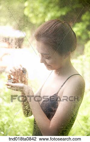 woman spreading aroma oil outside the glass pane View Large Photo Image Stock Image - woman spreading aroma oil outside the glass pane. Fotosearch