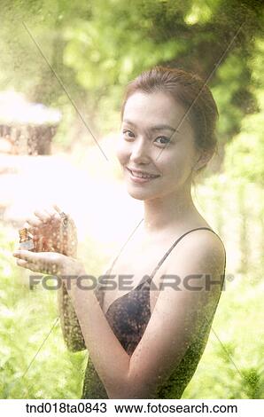 woman spreading aroma oil outside the glass pane, portrait View Large Photo Image Stock Image - woman spreading aroma oil outside the glass pane, portrait. Fotosearch