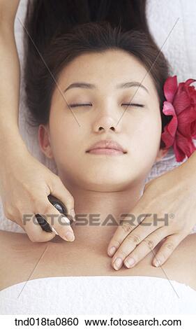 Stock Image - woman taking massage from massagist. Fotosearch