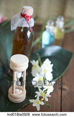 Stock Photograph - aroma theraphym oil and bottle and sandglass. Fotosearch