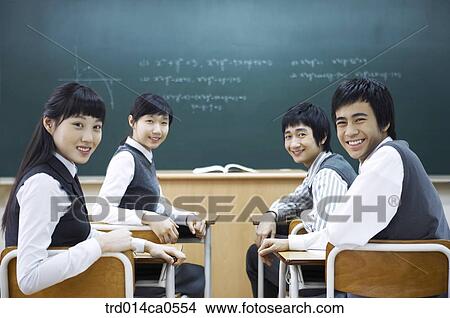 school uniform, classroom, education, table, boy View Large Photo Image Picture - school uniform, classroom, education, table, boy. Fotosearch