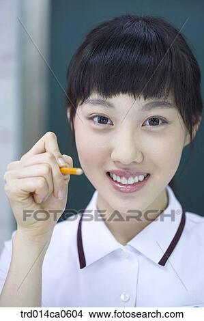Picture - school uniform, classroom, education, daytime, Asian, smile. Fotosearch