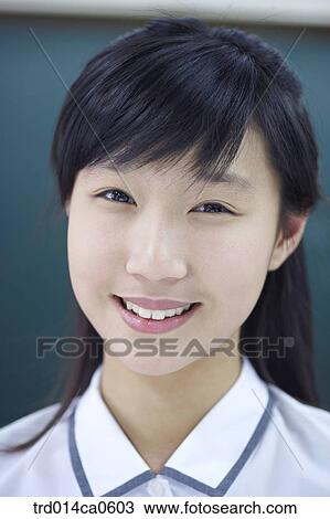 Stock Image - school uniform, classroom, education, daytime, Asian, smile. Fotosearch