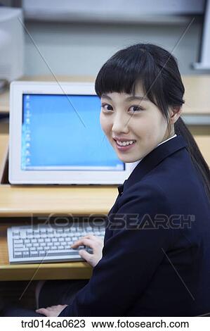 Stock Image - school uniform, classroom, education, daytime, Asian, person. Fotosearch