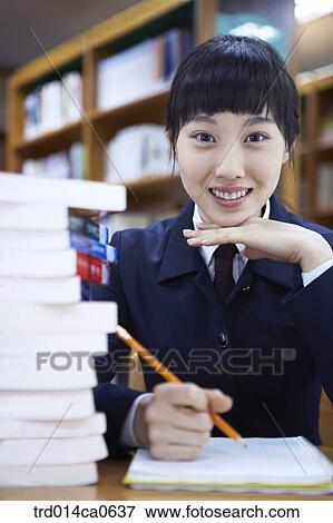 Stock Photo - school uniform, classroom, education, daytime, note, notebook. Fotosearch