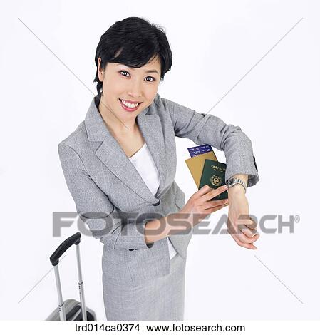 Picture - businesswoman, object, business, smile, Asian, airport. Fotosearch