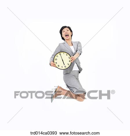 Stock Image - object, Asian, smile, wall clock, business, businesswoman. Fotosearch