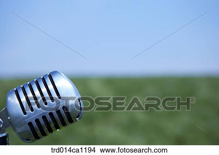 Picture - outdoor, rest, daytime, microphone, grassland, sky. Fotosearch