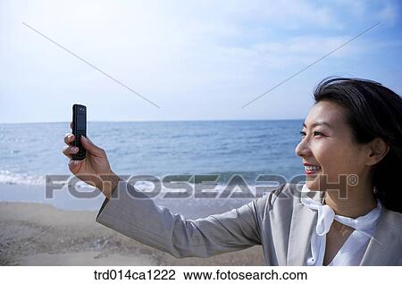 Stock Image - person, Asian, woman, outdoor, business, rest. Fotosearch