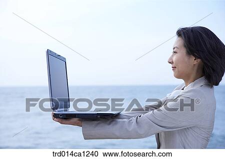 Stock Image - person, Asian, woman, outdoor, business, rest. Fotosearch