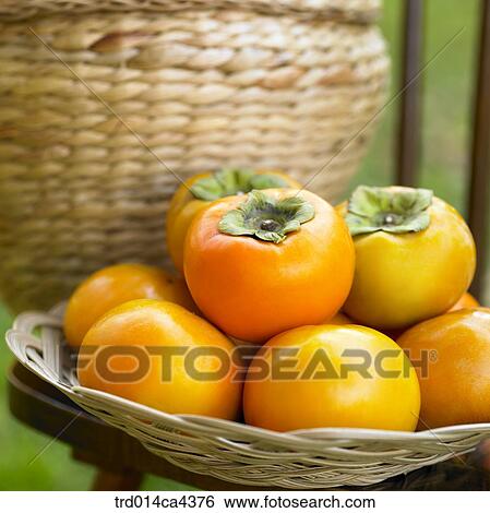Stock Photograph - fruit, persimmon, basket. Fotosearch