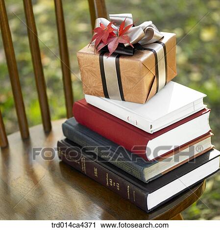 Stock Image - present, fall, books, book, chair, gift, autumn. Fotosearch