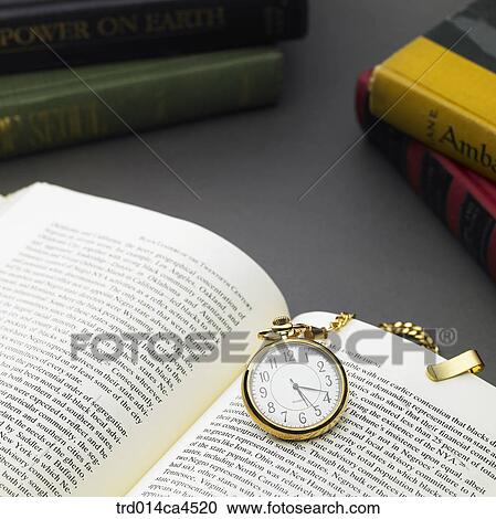 Stock Image - indoor, day, daytime, highangle, highangleview, book, pocketwatch. Fotosearch