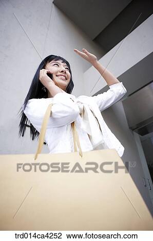 Stock Image - smile, gesture, call, telephone, call, phone, cellphone. Fotosearch