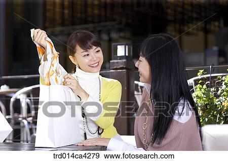 Stock Photo - smile, laugh, laughter, present, gift, paperbag, self-praise. Fotosearch