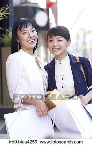 Stock Photo - smile, laugh, laughter, shopping, paperbag, shoppingbag, present. Fotosearch
