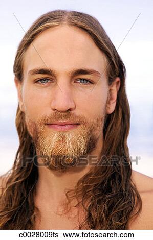 Close Up Portrait Of A Man With Wet Long Hair And A Beard Looking