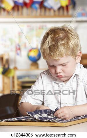 Adult Helping Two Young Children at Montessori/Pre-School View Large Photo Image Stock Photography - Adult Helping Two Young Children at Montessori/Pre-School. Fotosearch