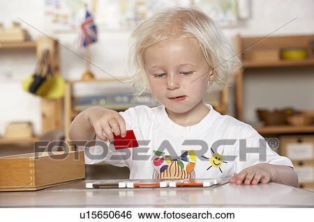 Adult Helping Young Children at Montessori/Pre-School View Large Photo Image Stock Photograph - Adult Helping Young Children at Montessori/Pre-School. Fotosearch