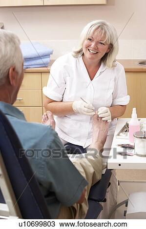 Chirpodist treating client in clinic View Large Photo Image Stock Image - Chirpodist treating client in clinic. Fotosearch