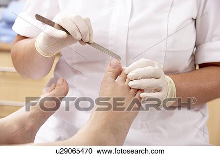 Chirpodist treating client in clinic View Large Photo Image Stock Image - Chirpodist treating client in clinic. Fotosearch