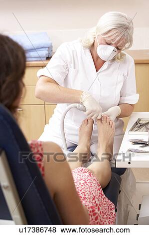 Chirpodist treating client in clinic View Large Photo Image Stock Photo - Chirpodist treating client in clinic. Fotosearch