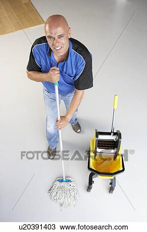 Cleaner mopping office floor View Large Photo Image Stock Image - Cleaner mopping office floor. Fotosearch