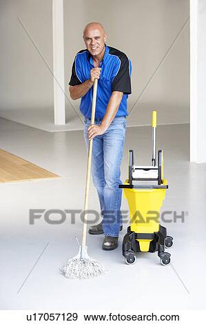 Cleaner mopping office floor View Large Photo Image Stock Photo - Cleaner mopping office floor. Fotosearch